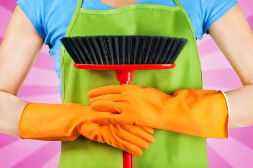 Technician checking cleaning equipment and chemical safety procedures