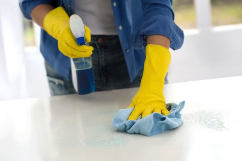 Technician performing carpet stain removal in Perivale